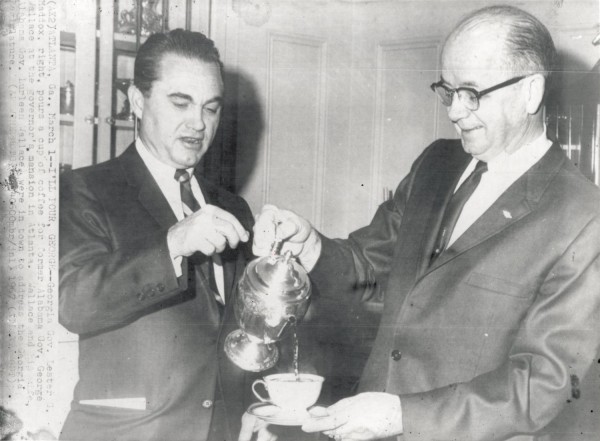 Photographic print of Governor Lester G. Maddox pouring coffee from a pot into a cup held by George Wallace, both dressed in suits