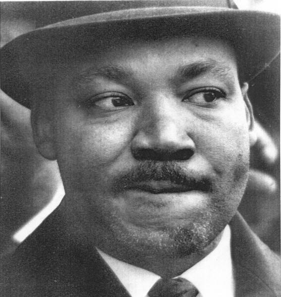 Photographic print of Dr. Martin Luther King, Jr., a close-up portrait of a man wearing a brimmed hat, suit, and tie, looking slightly to one side
