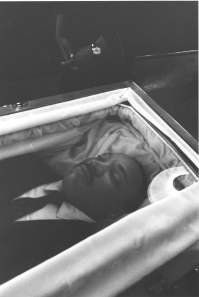 Photographic print of Dr. Martin Luther King, Jr. lying in state in a satin-lined, glass-enclosed coffin, viewed from above