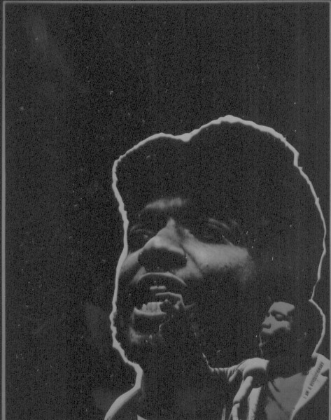 Artifact poster with a black-and-white close-up photograph of Fred Hampton speaking, his face upturned, outlined in white against a dark background