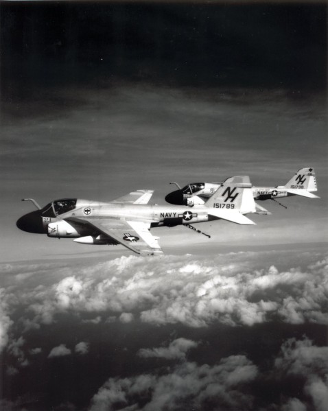 Photographic print of two Navy A-6A Intruder aircraft marked '151789' and '151798' flying in formation above cloud cover with tailhooks extended