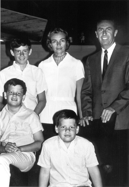 Photographic print of Sandra Day O'Connor and her family posing together, with a man in a suit and tie and three young boys in casual shirts